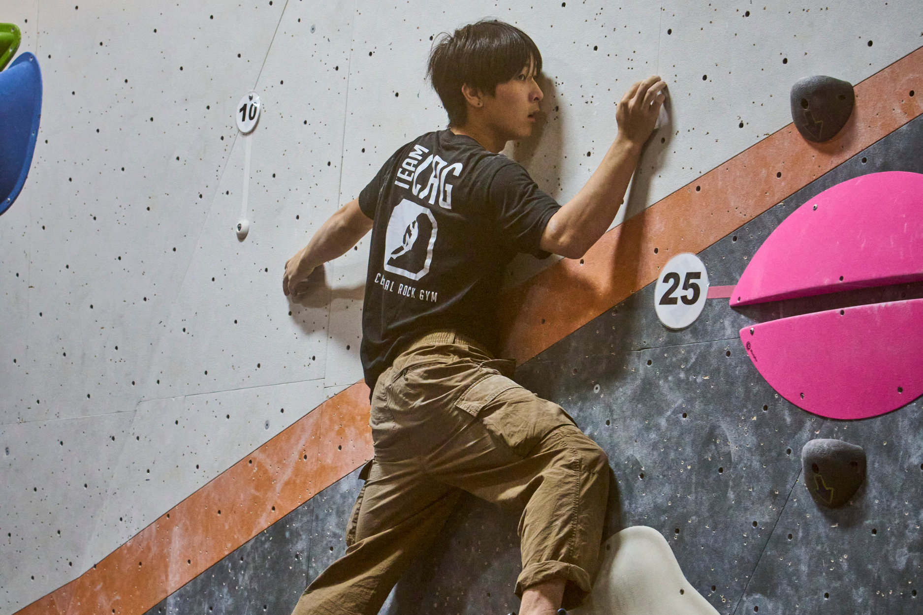 A crg team boy tries to complete a slab boulder