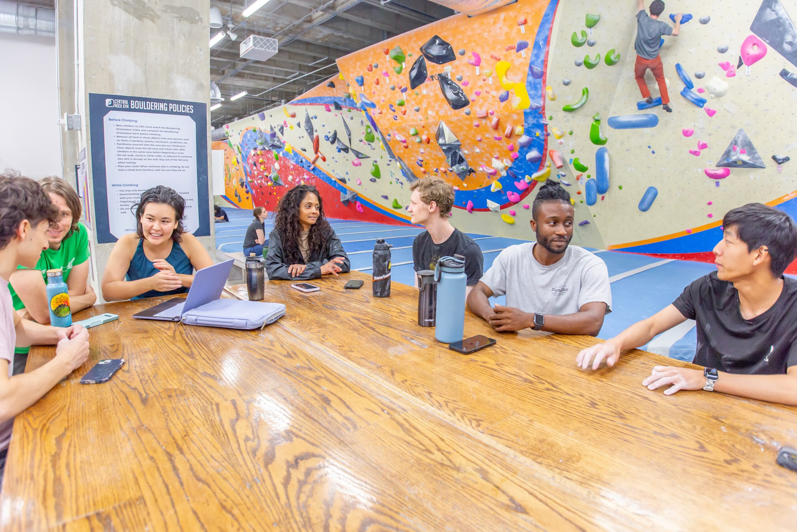 Group of people sitting at a table presumably talking about work.