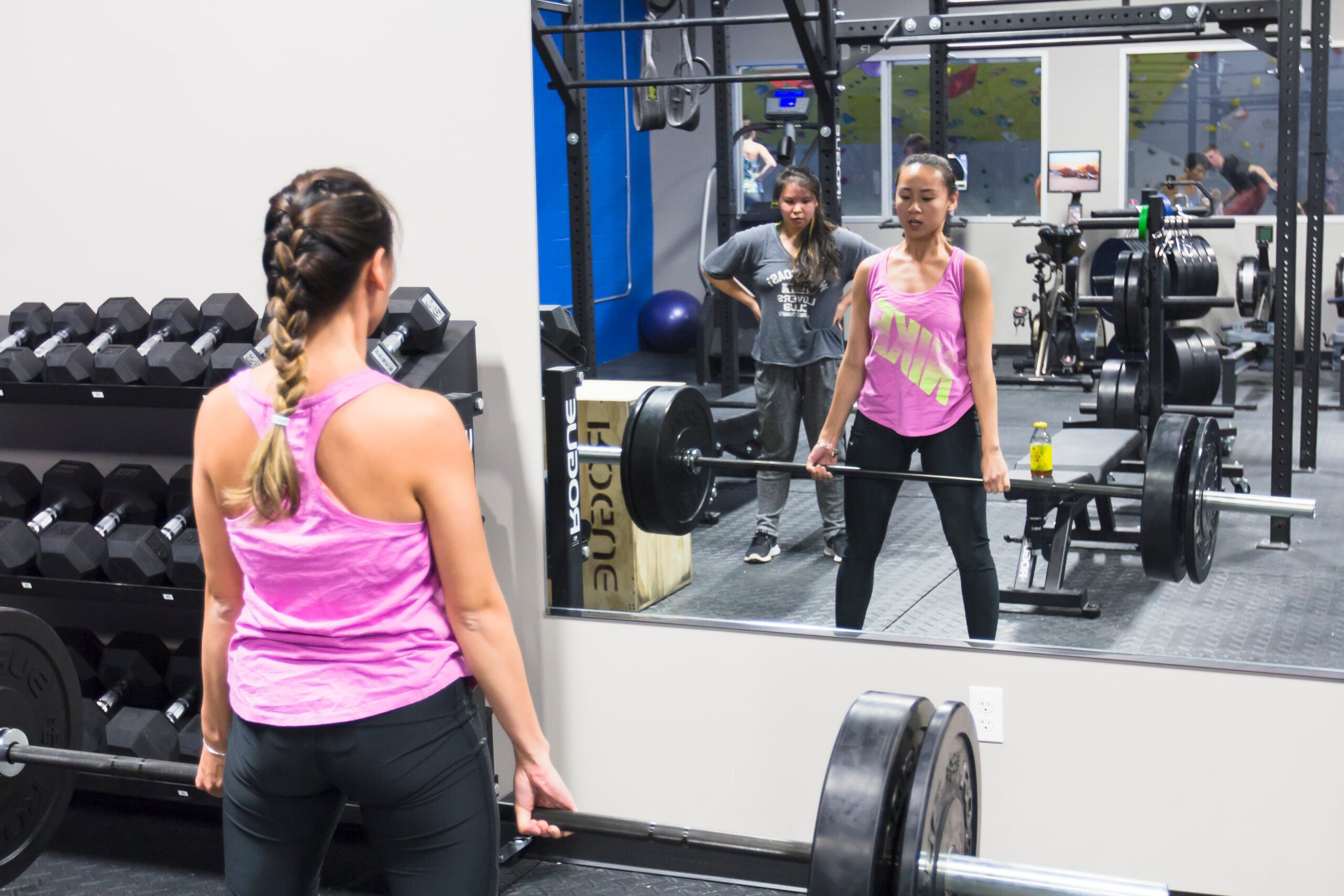 In a weightlifting class a woman performs a deadlift at Central Rock Gym Framingham