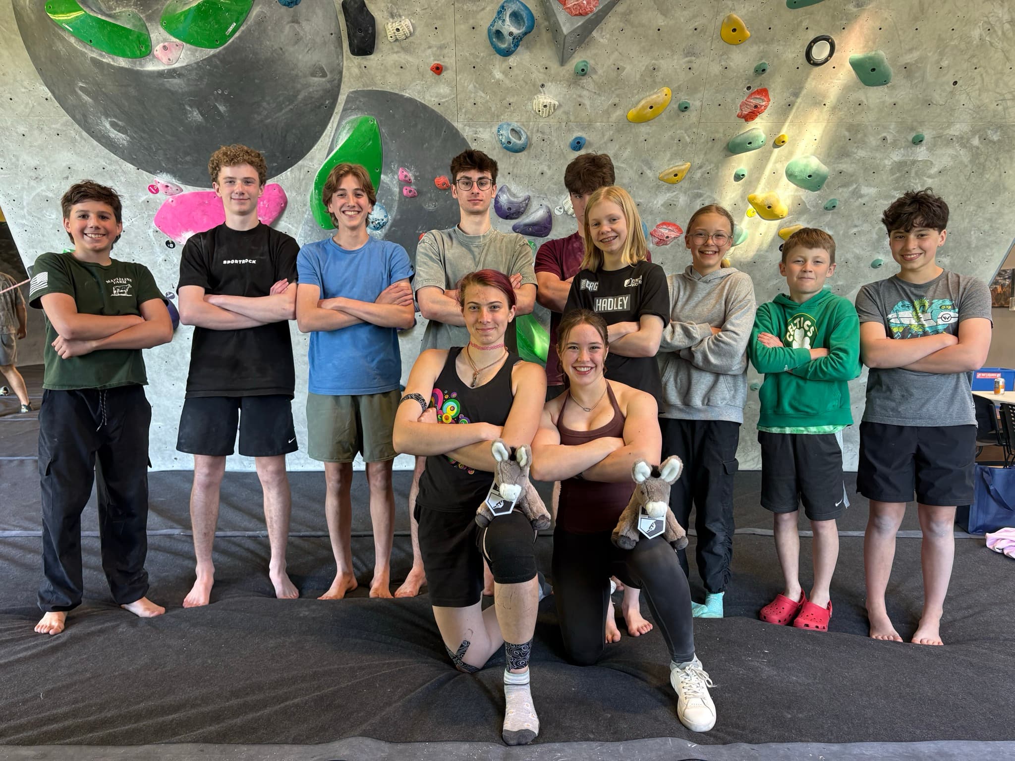 CRG Hadley 2026 Youth Competitive team photo. Kids standing in front of a bouldering wall.