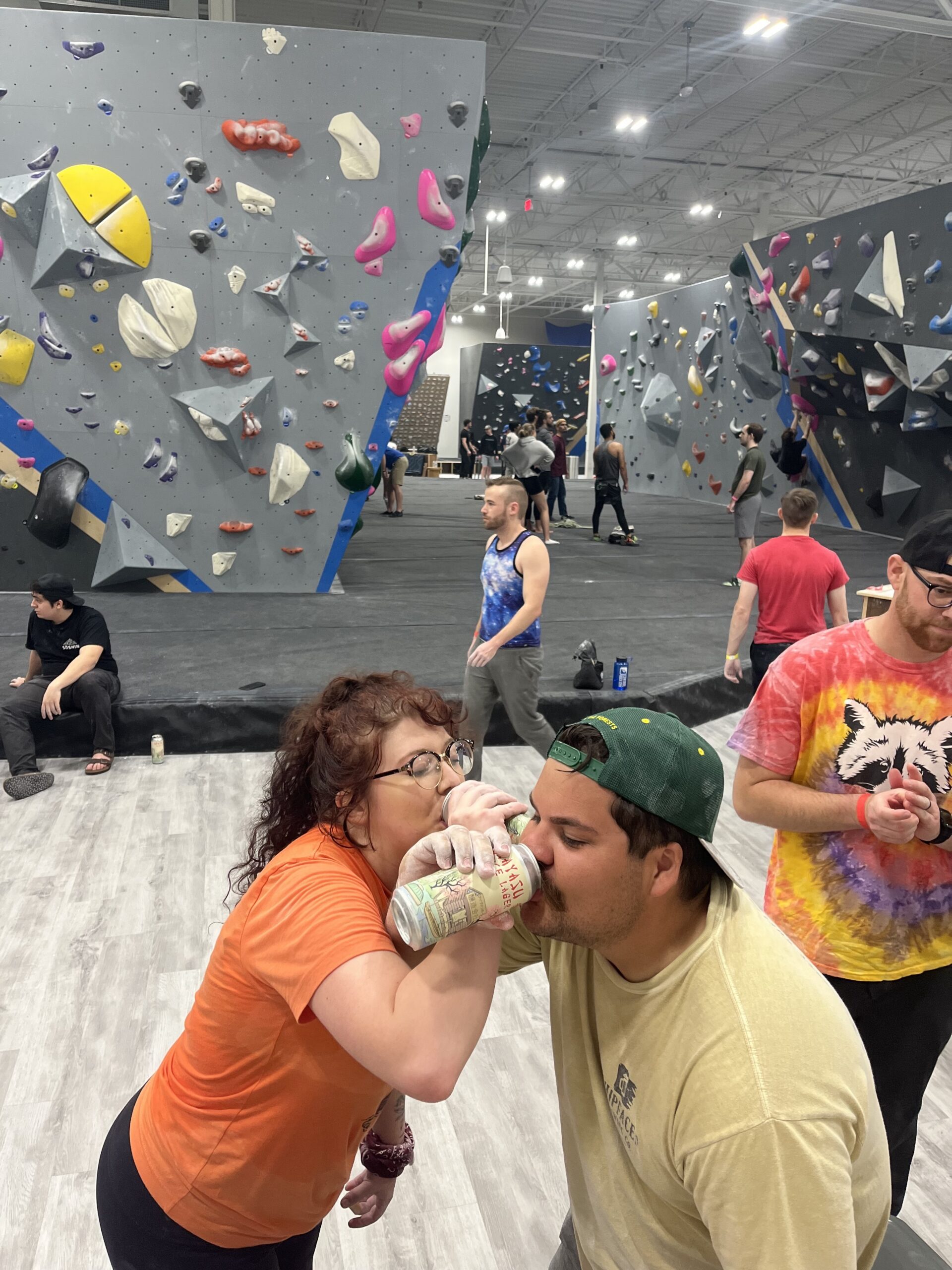 two people crossing arms as they drink during boulders and brews.