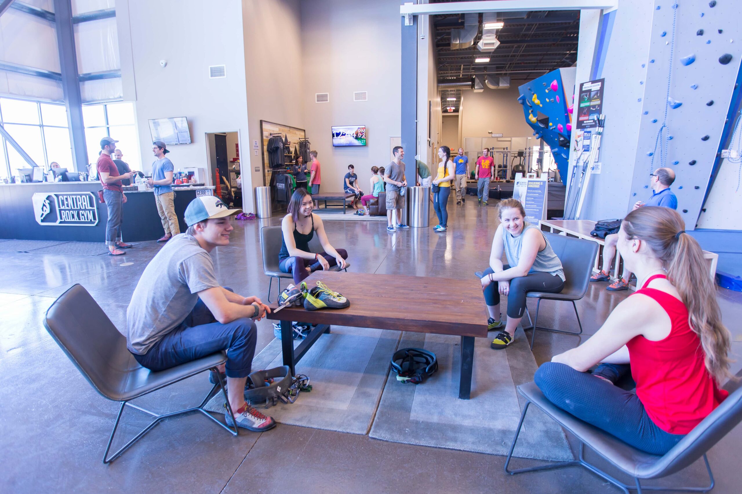 A group of climbers sits and talks around a coffee table