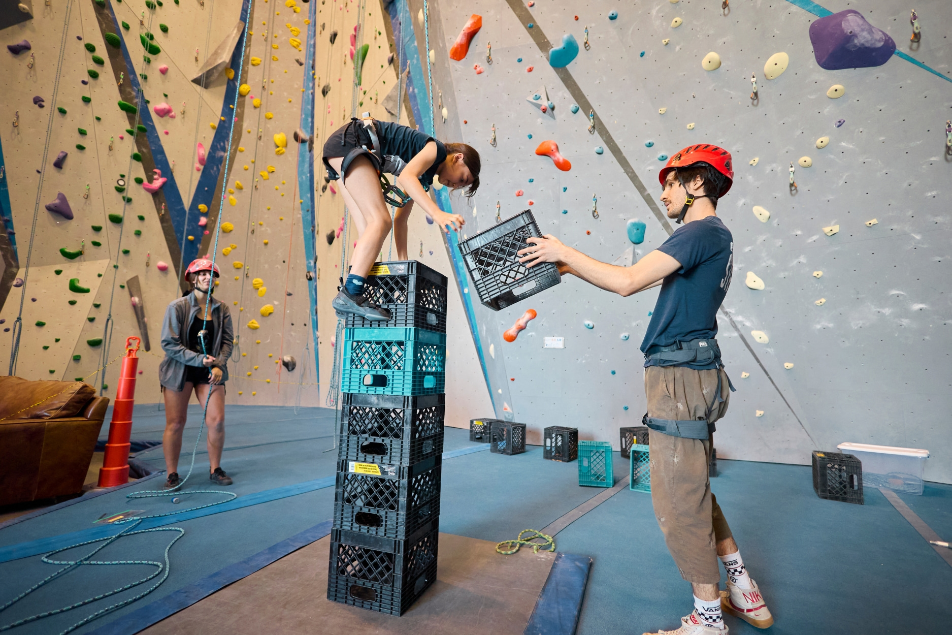 Child climbing crates during crate stacking activity at Kids Night Out.