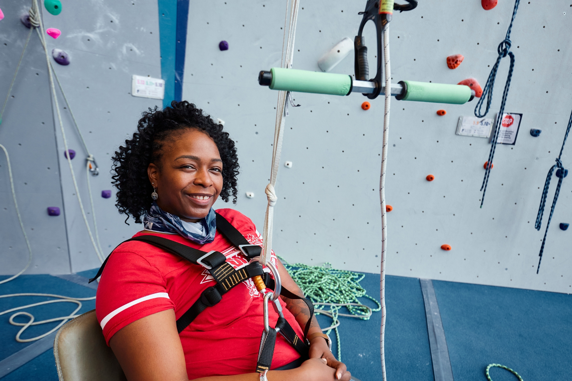 Adaptive climber preparing for her climb using the easy-seat set up.