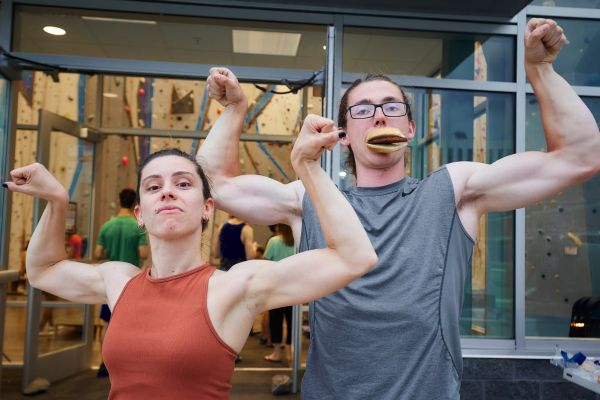 Climbers posing for photo showing off their muscles at Boulders & Brews