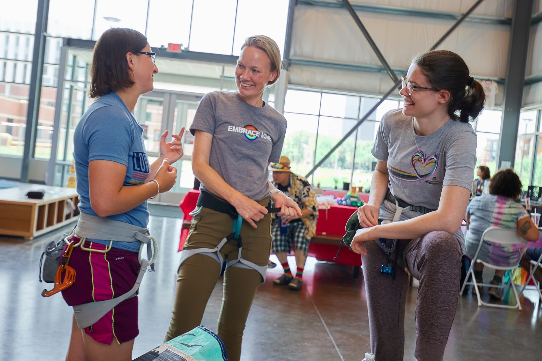 Three girls chatting about their climbs at Central rock gym