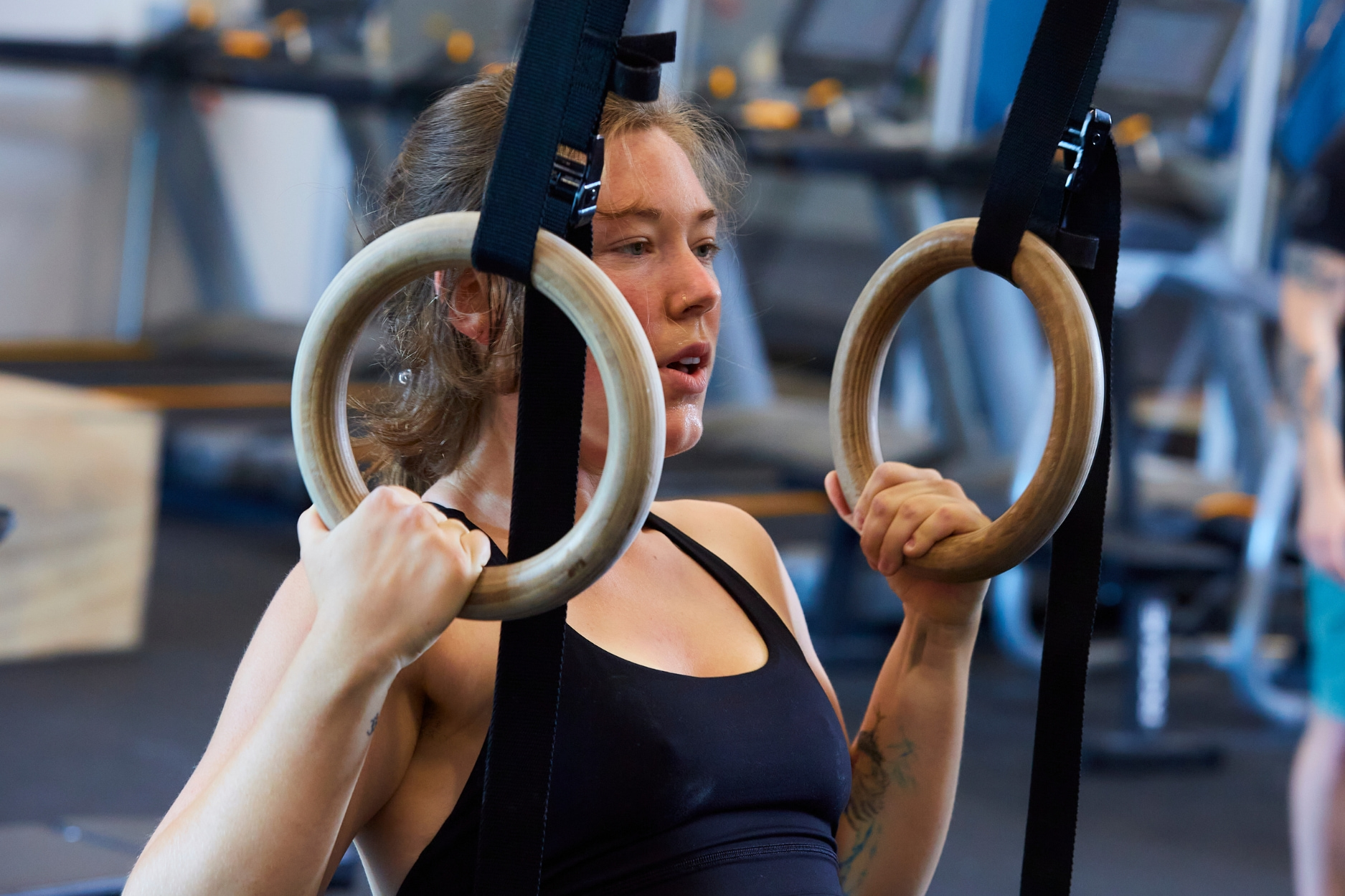 Image of women doing ring rows in the fitness room.