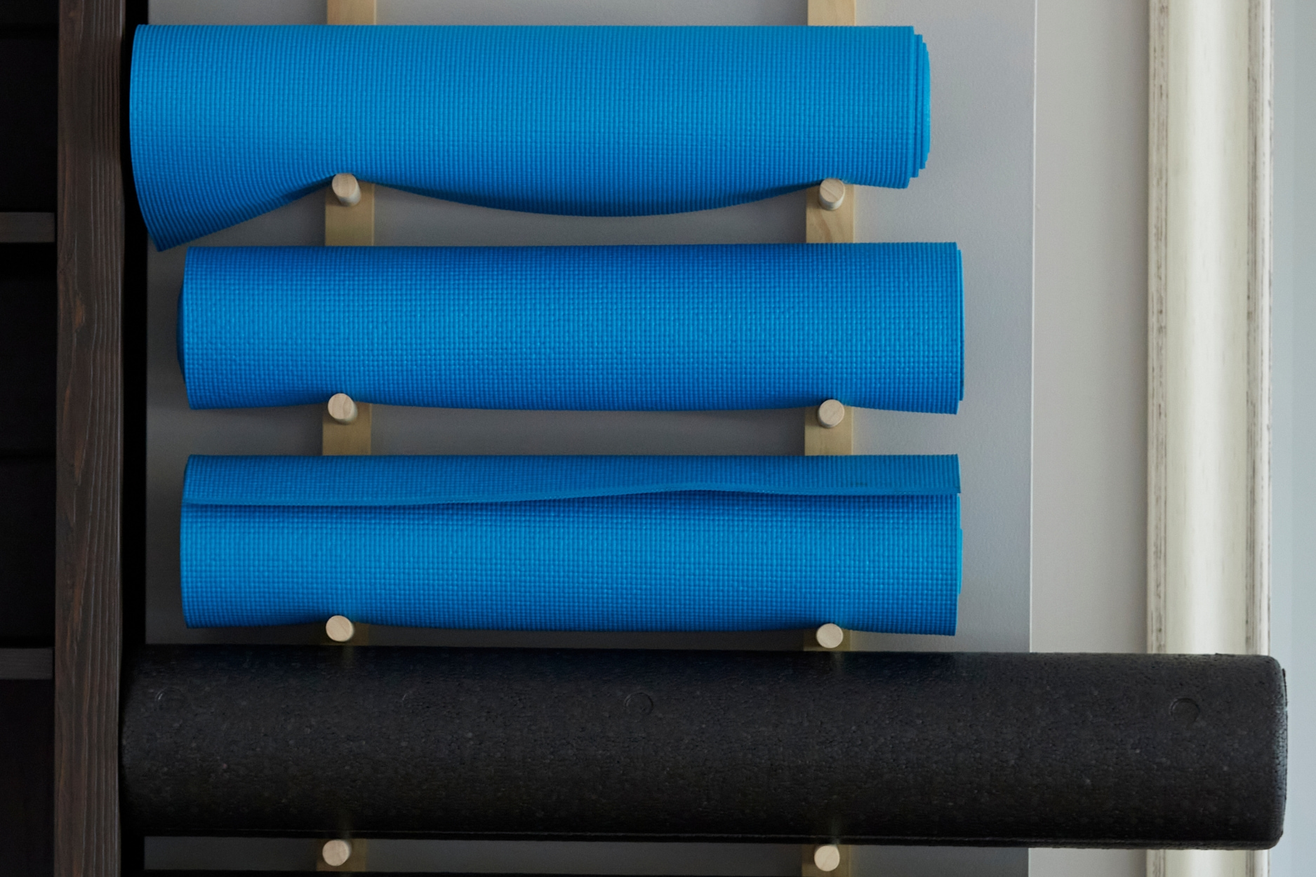 Image of yoga mats mounted on the wall.