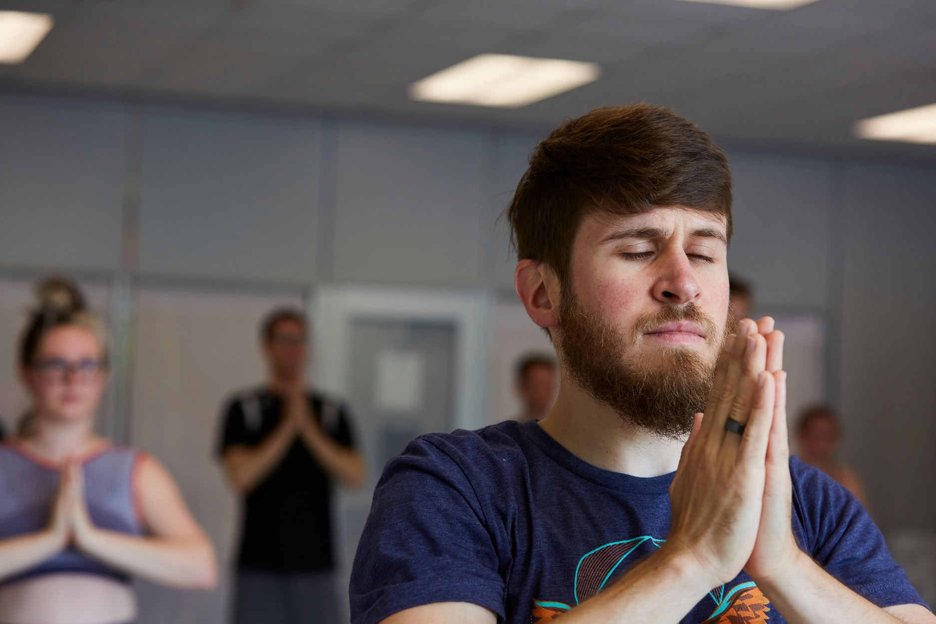 Yoga instructor hold a pose during yoga class.