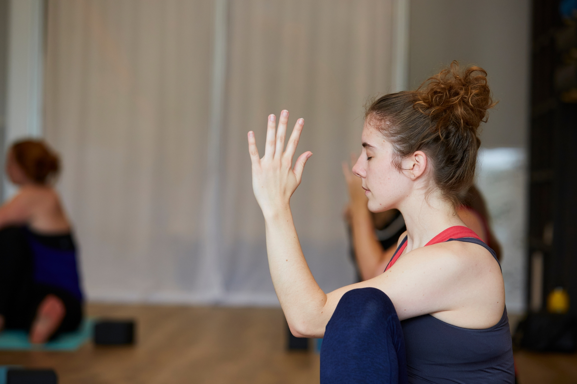 Woman holding yoga pose during class.