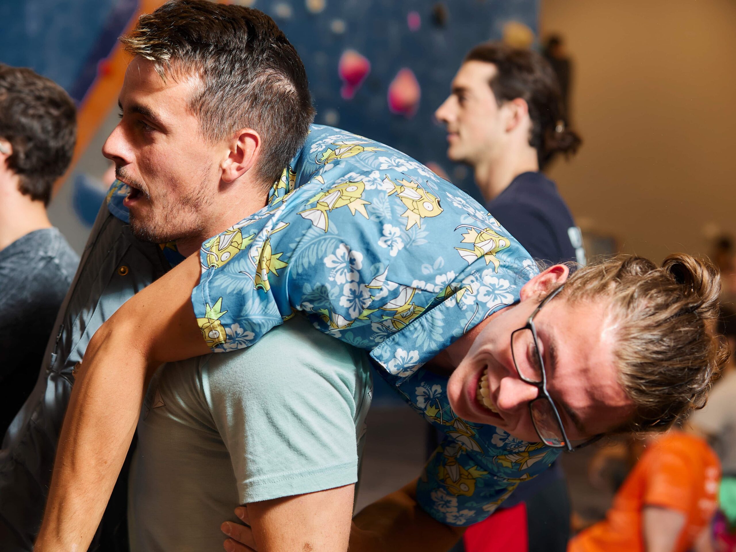 Friends goofing around in the bouldering area with one friend carrying the other