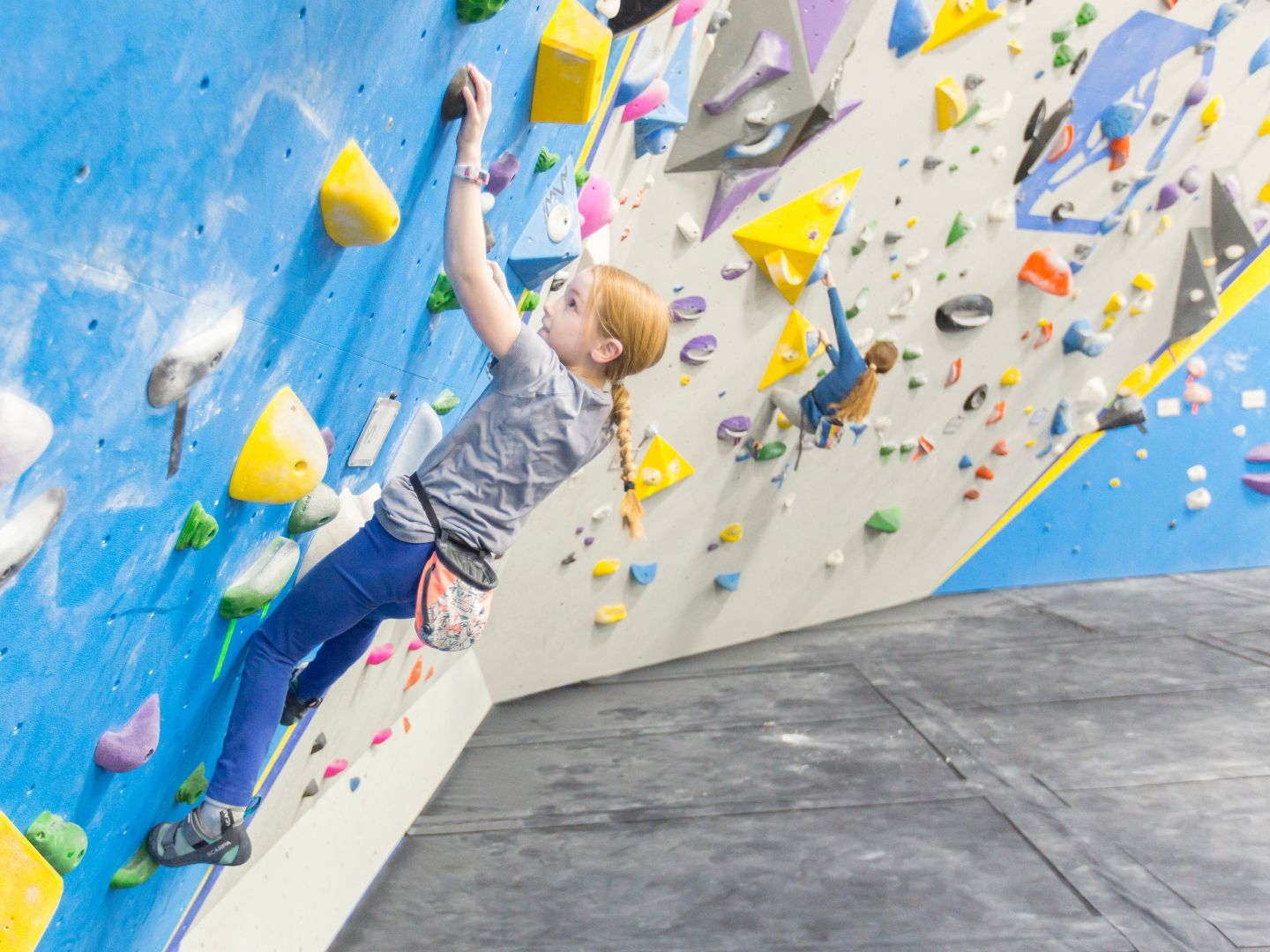 A young child boulders at Central Rock Gym Stoneham