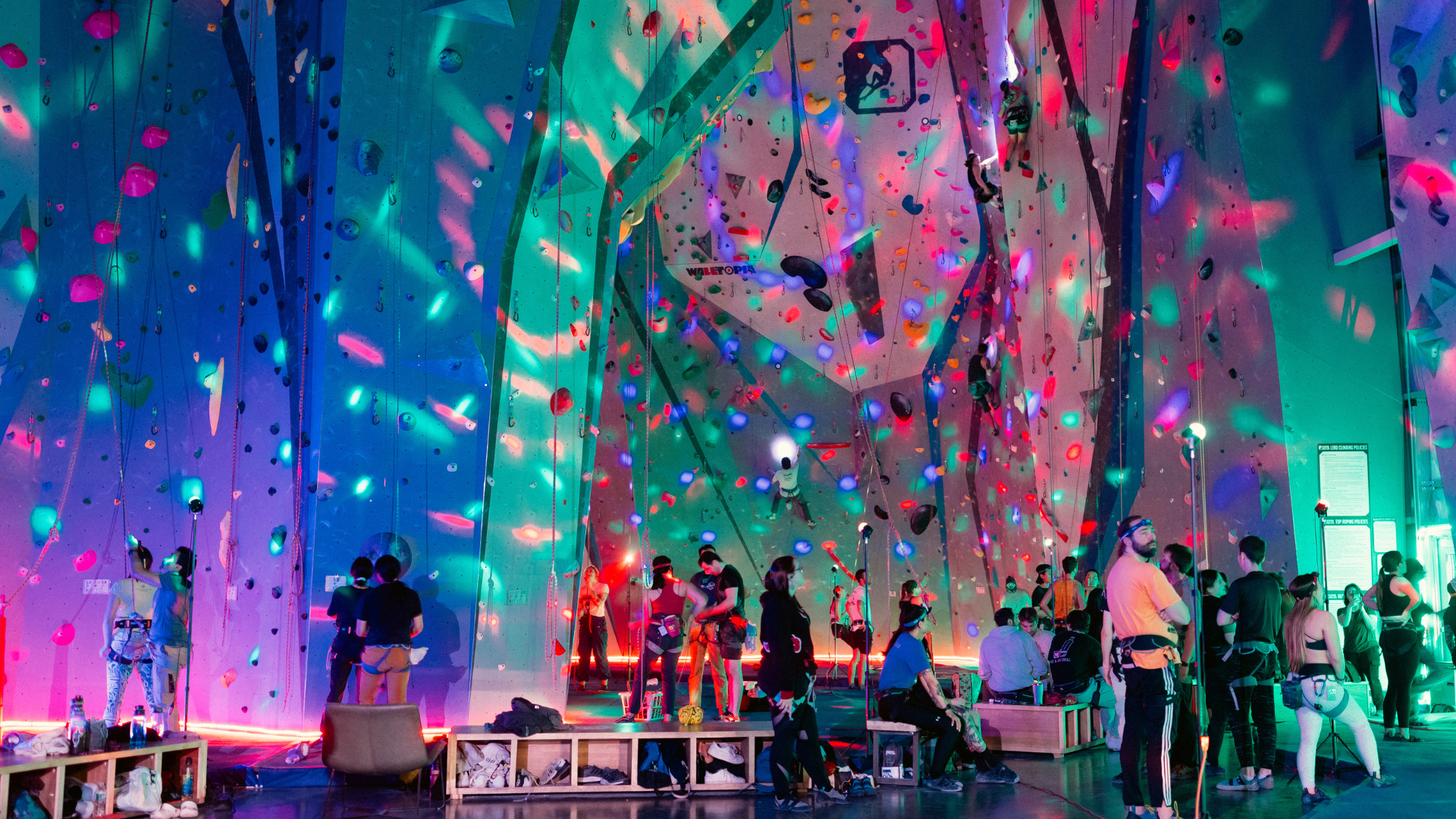 Climbers climbing and hanging out in a gym with party LED lights and head lamps!
