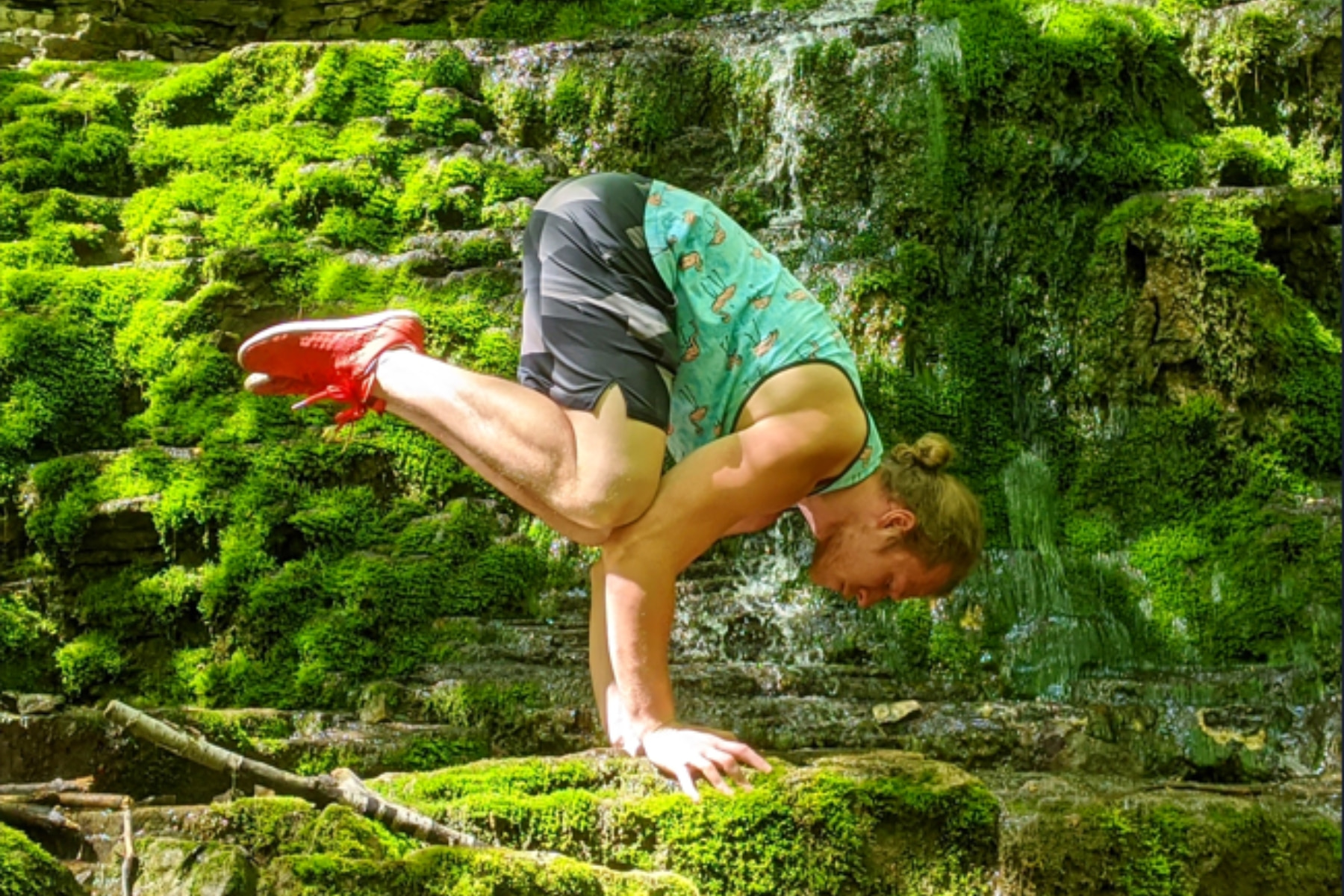 Yoga instructor outside in crow pose, bakasana.