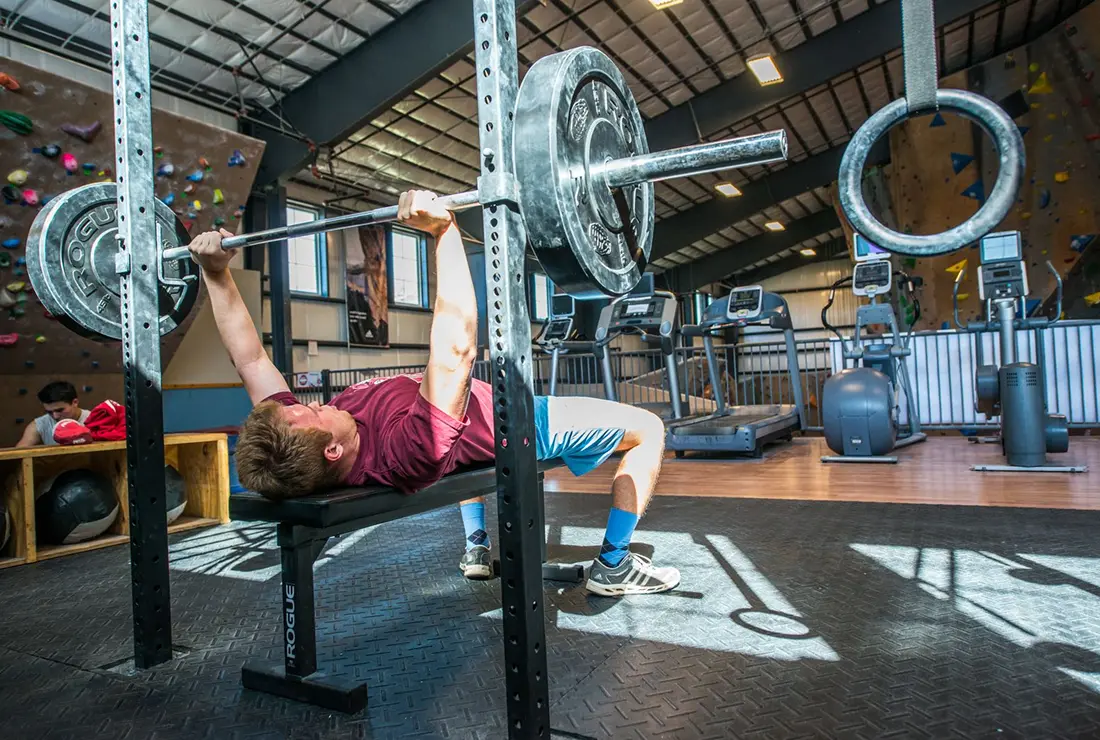 A man bench pressing at Central rock gym