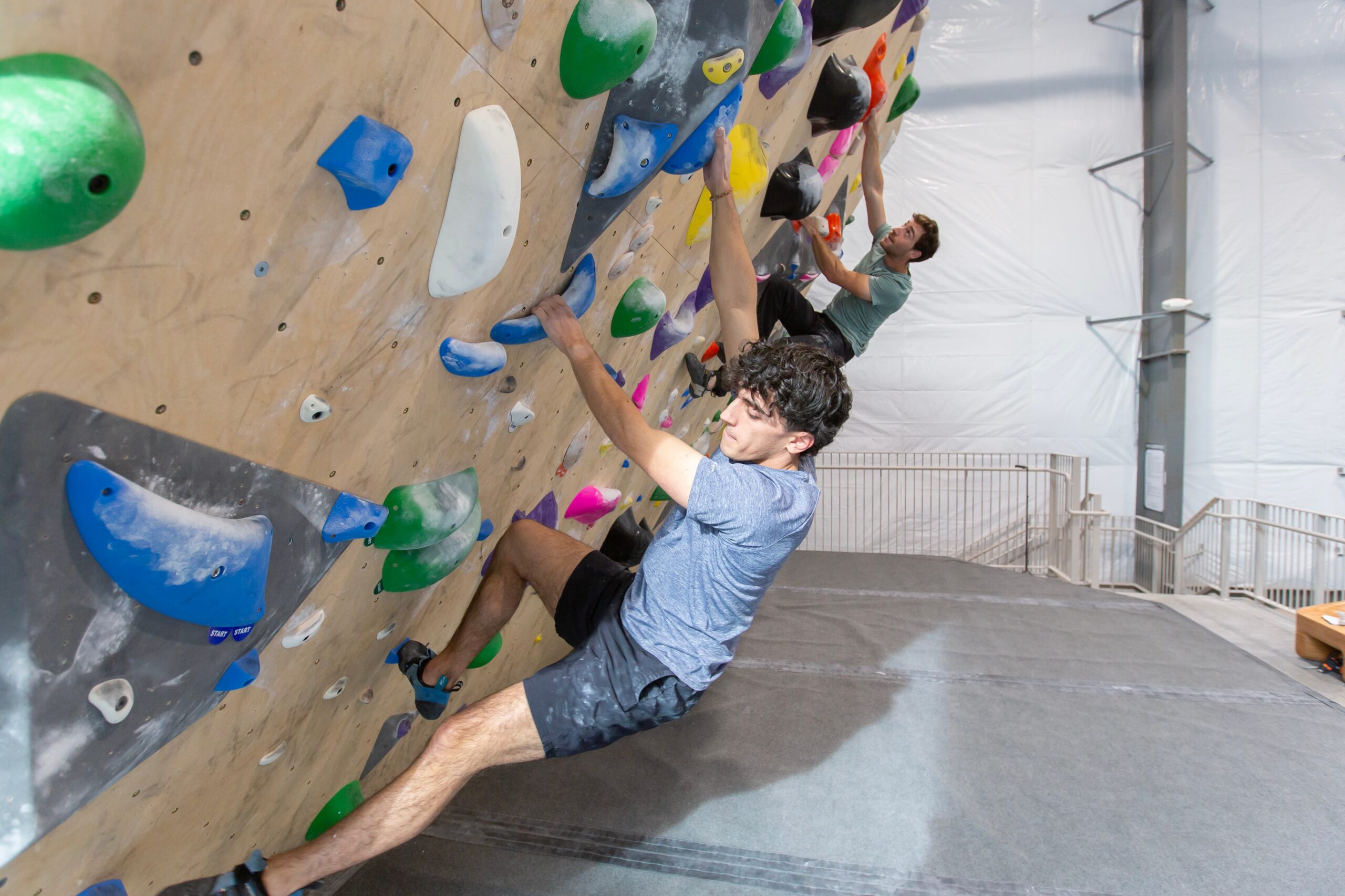 A man is bouldering at Central rock gym