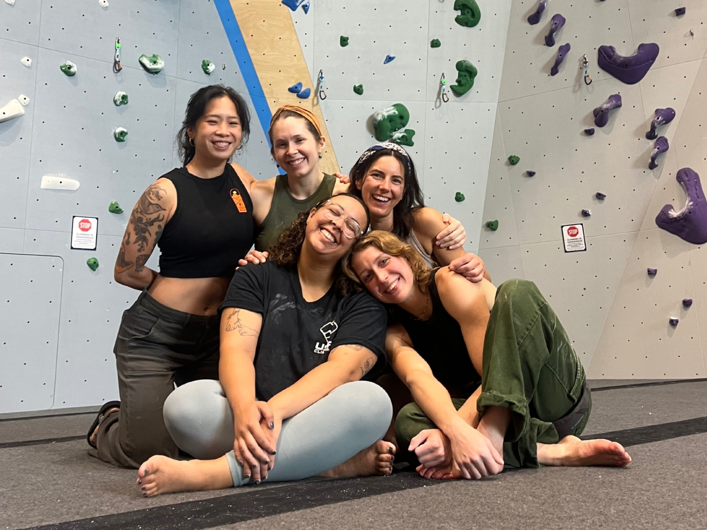 A group of women smiling at the camera with arms around each other.