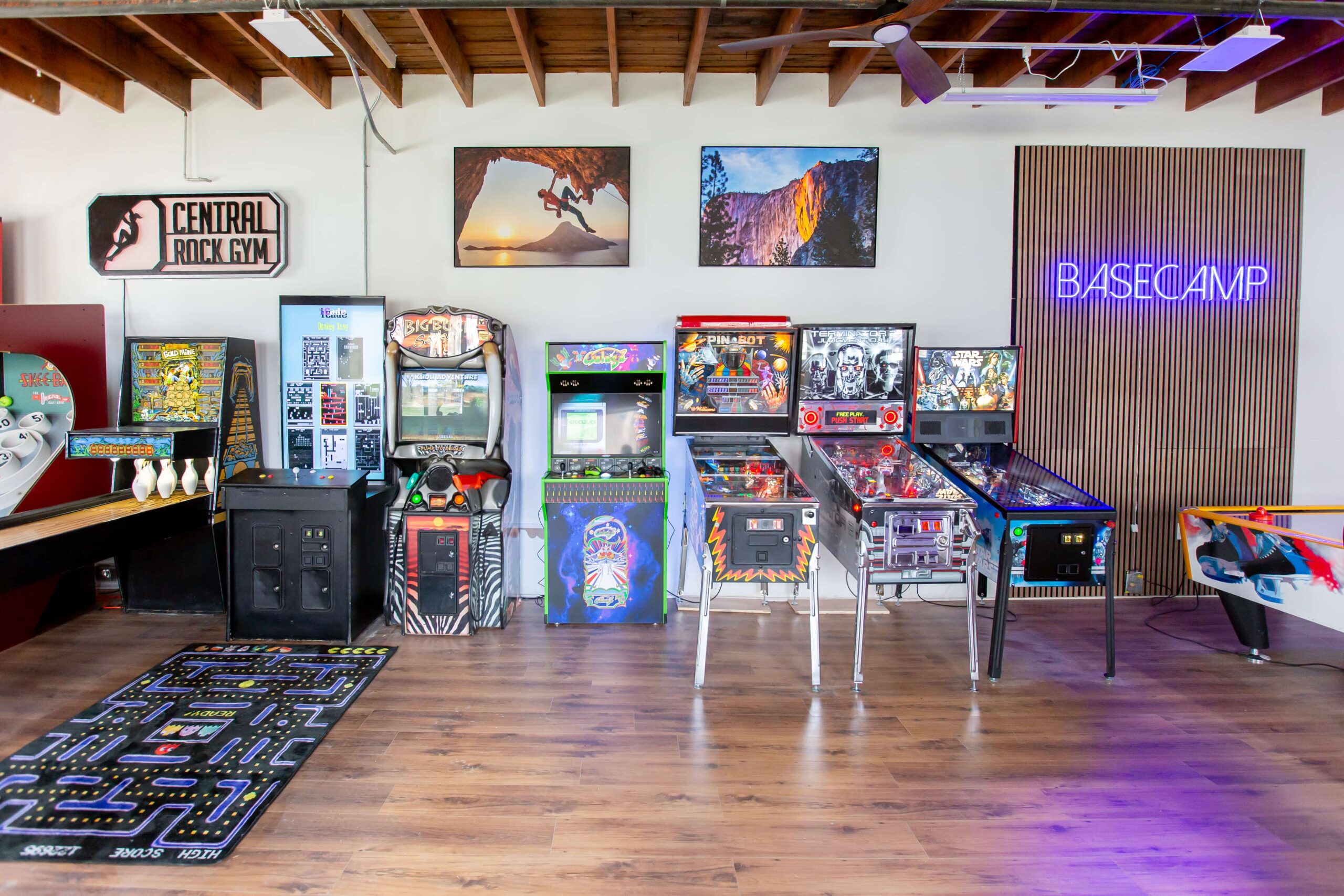 An arcade area with pinball machines and air hockey.