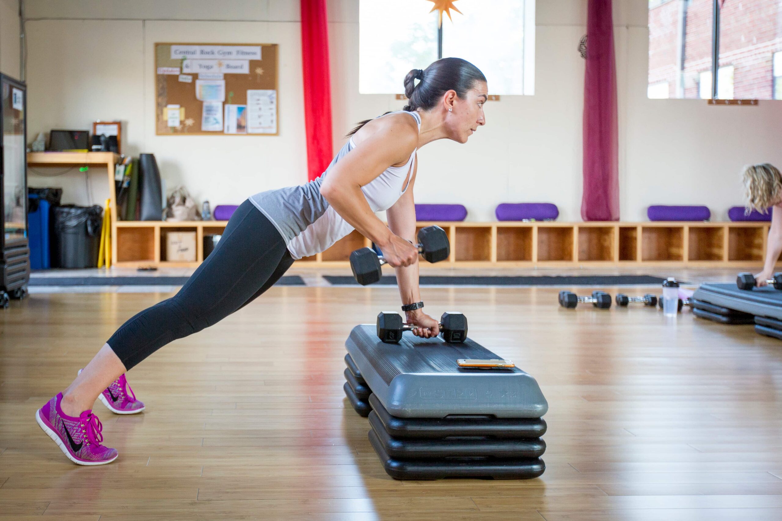 Customer performing core exercise during fitness class.