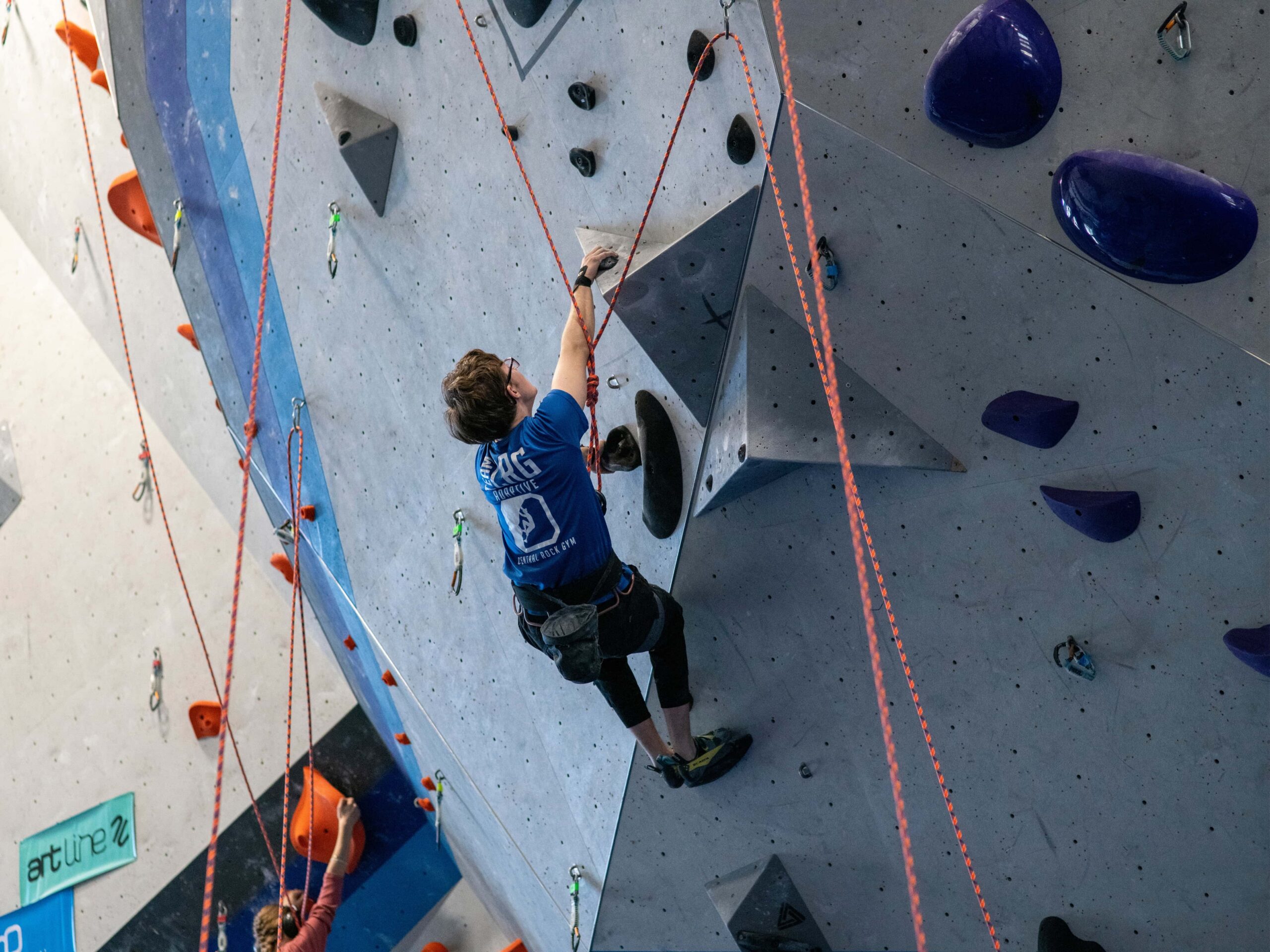 A Central Rock Gym adaptive team climber competes in an adaptive climbing event at the Randolph location.
