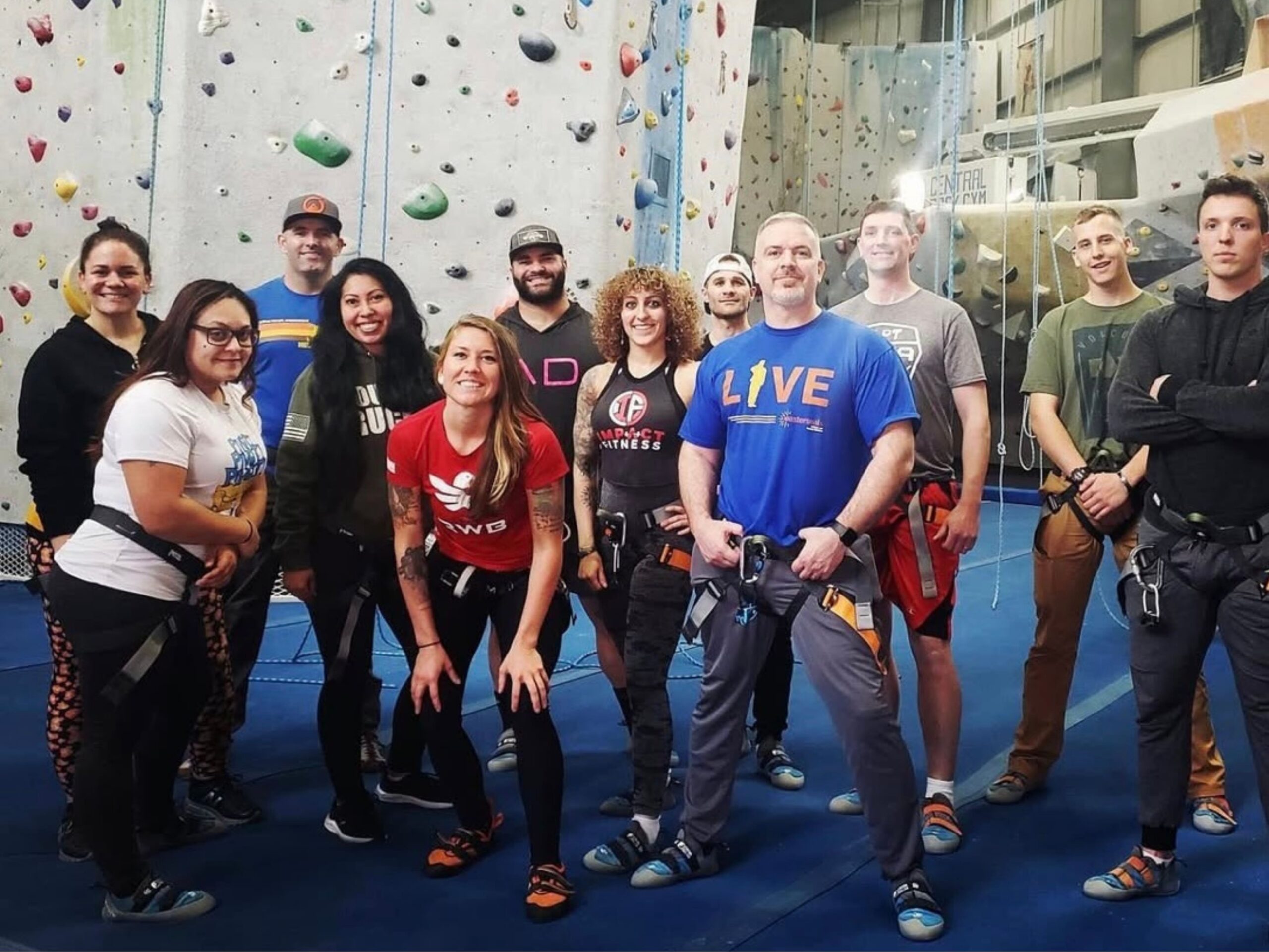 A group of rope climbers gathering for a picture at the end of a fun top roping session.