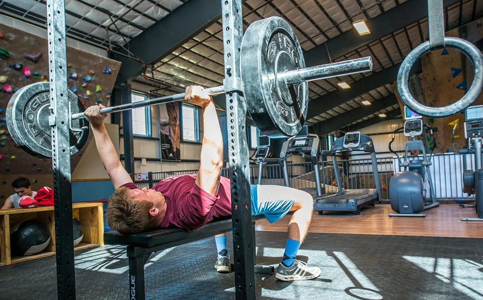 A man bench presses.