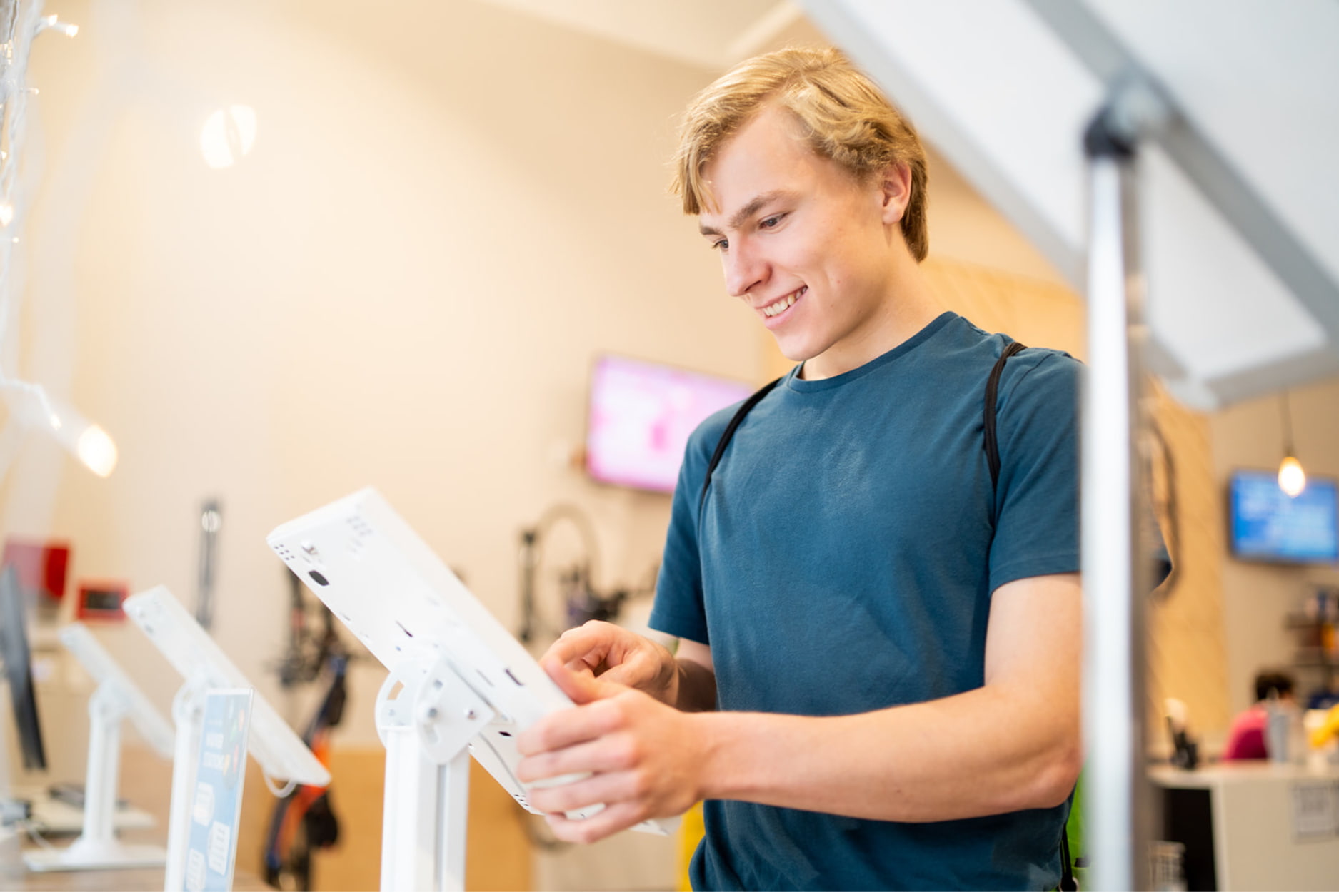 A young man signs a participation agreement on an ipad prior to climbing at Central Rock Gym.