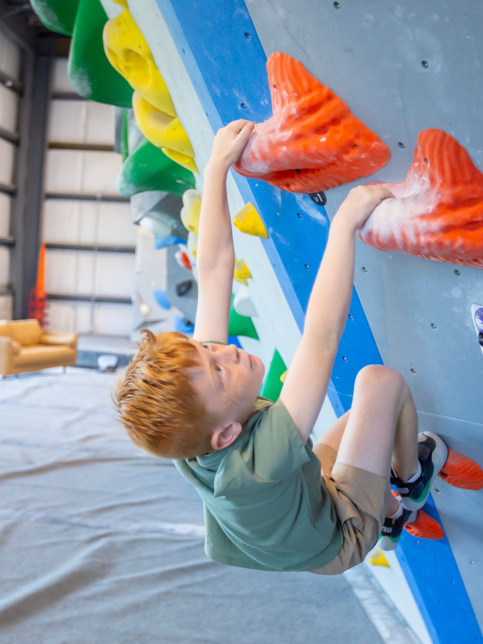 boy bouldering at central rock gym