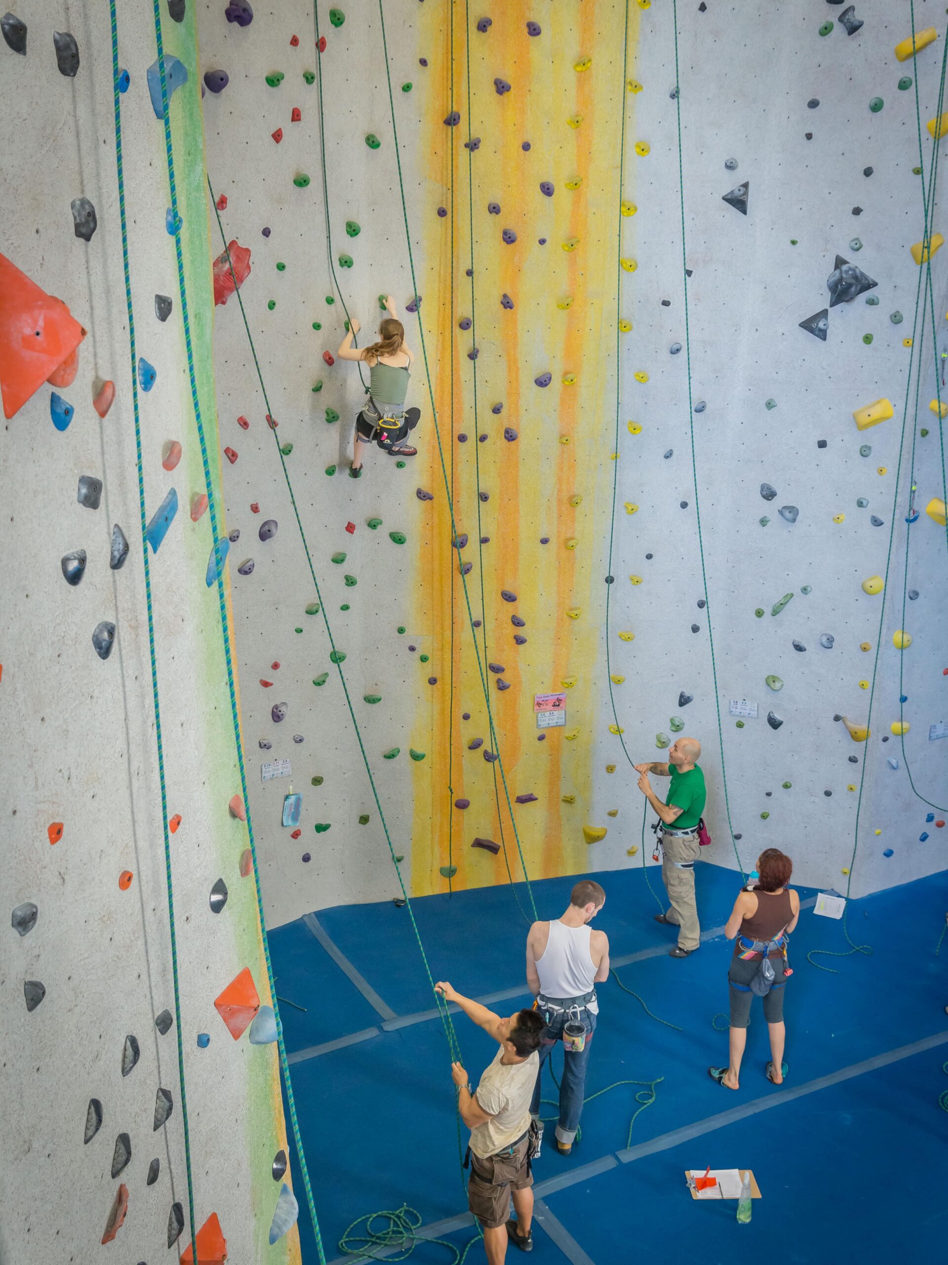 A group of people rope climb at Central Rock Gym Worcester.