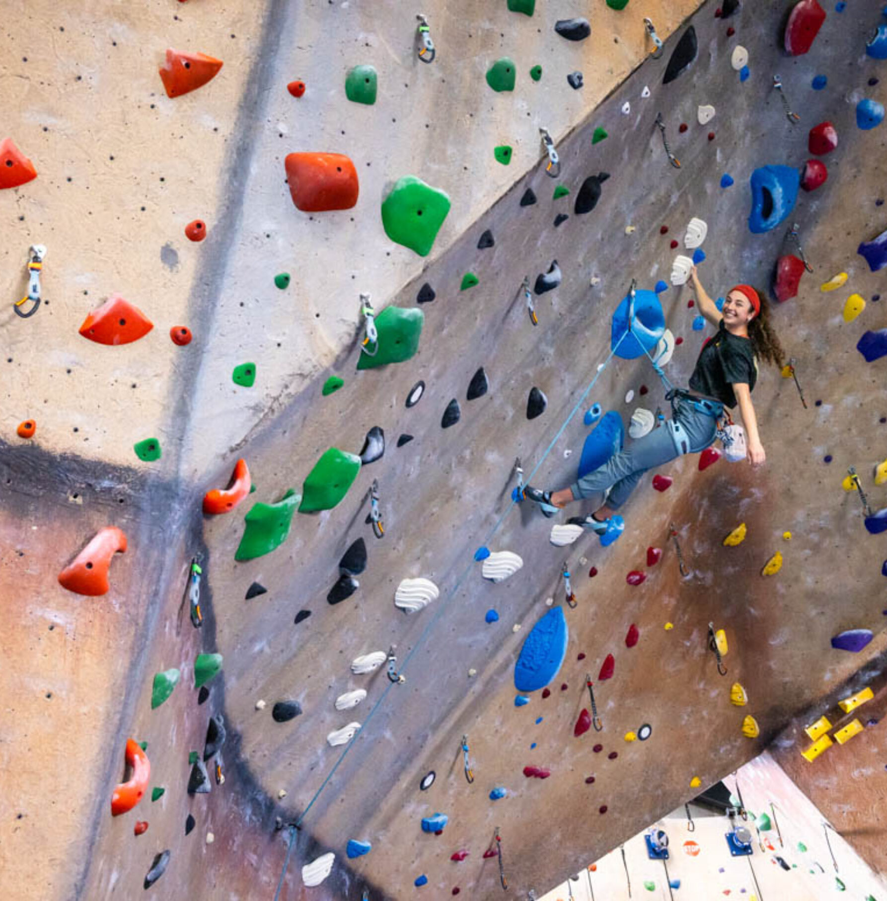 A girl top rope climbing at Central Rock Gym