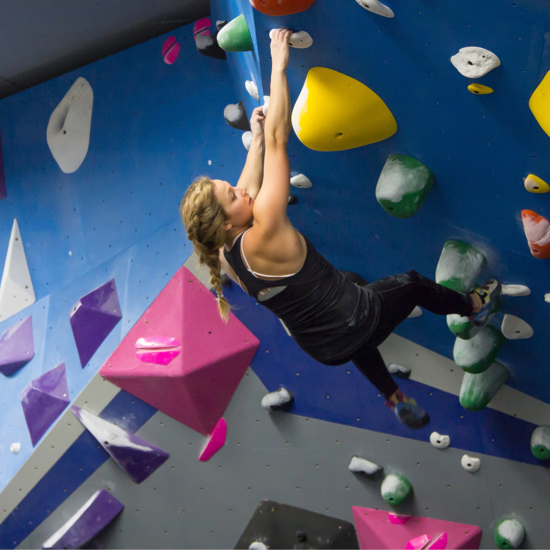 a women bouldering at central rock gym