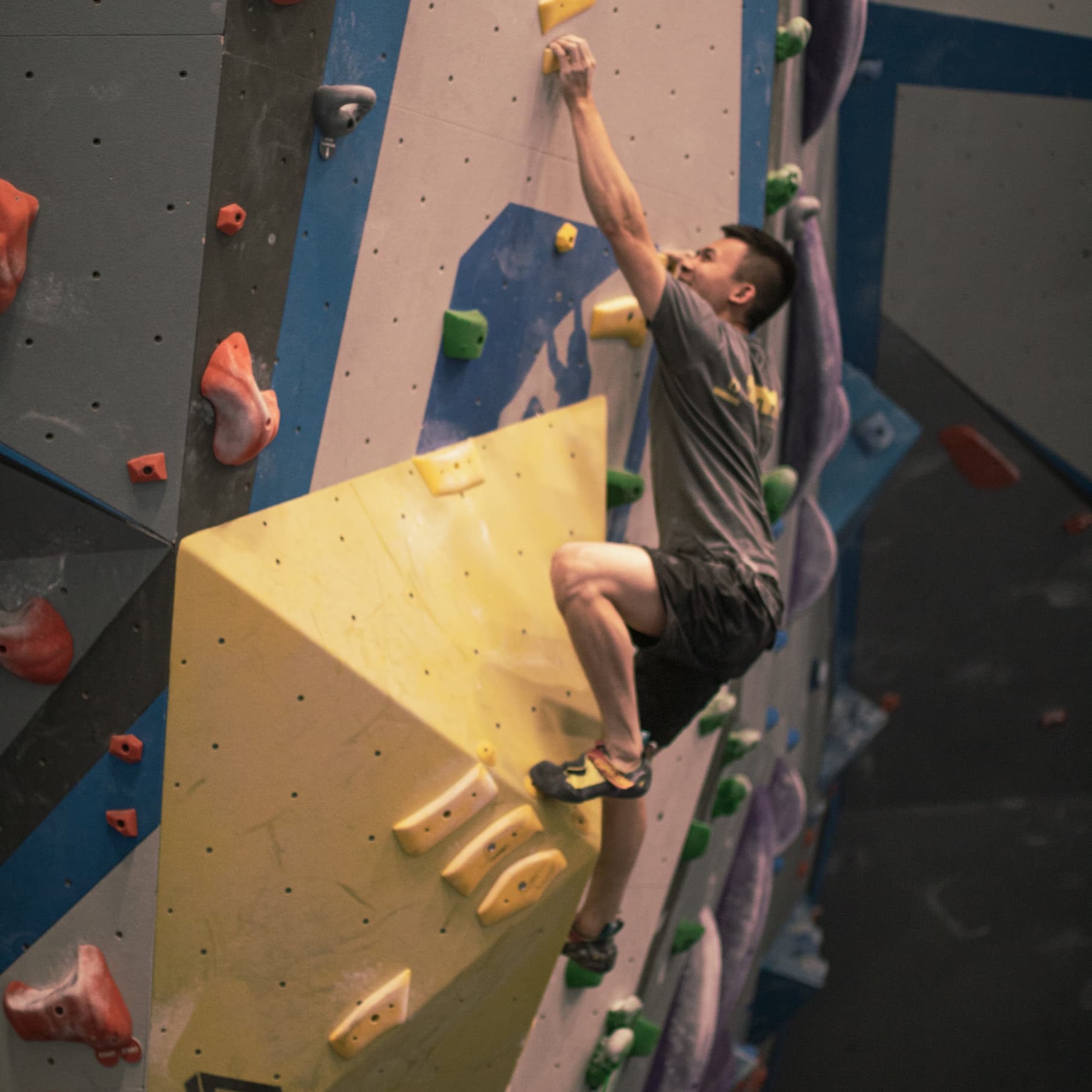 a man bouldering at central rock gym