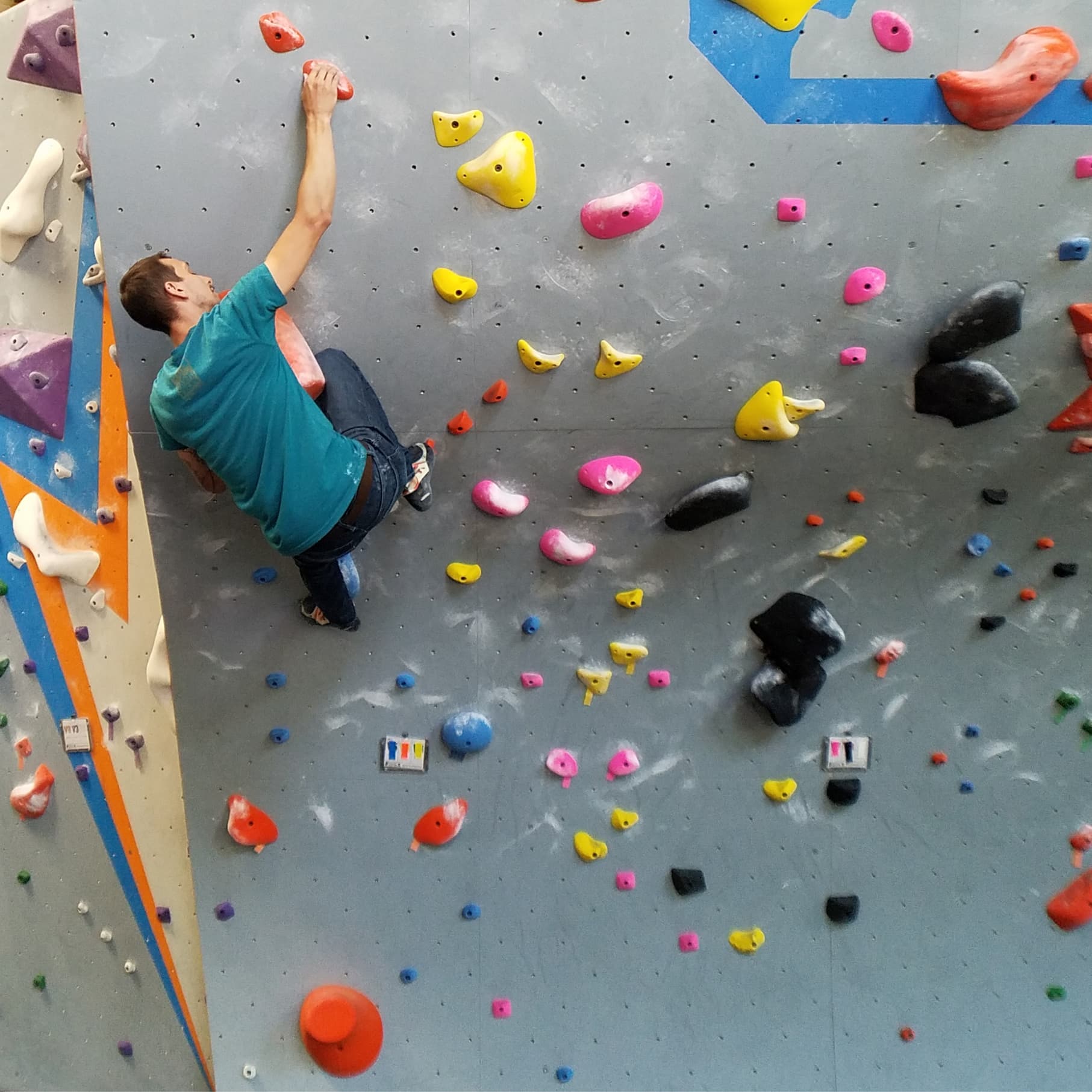 A man bouldering at central rock gym