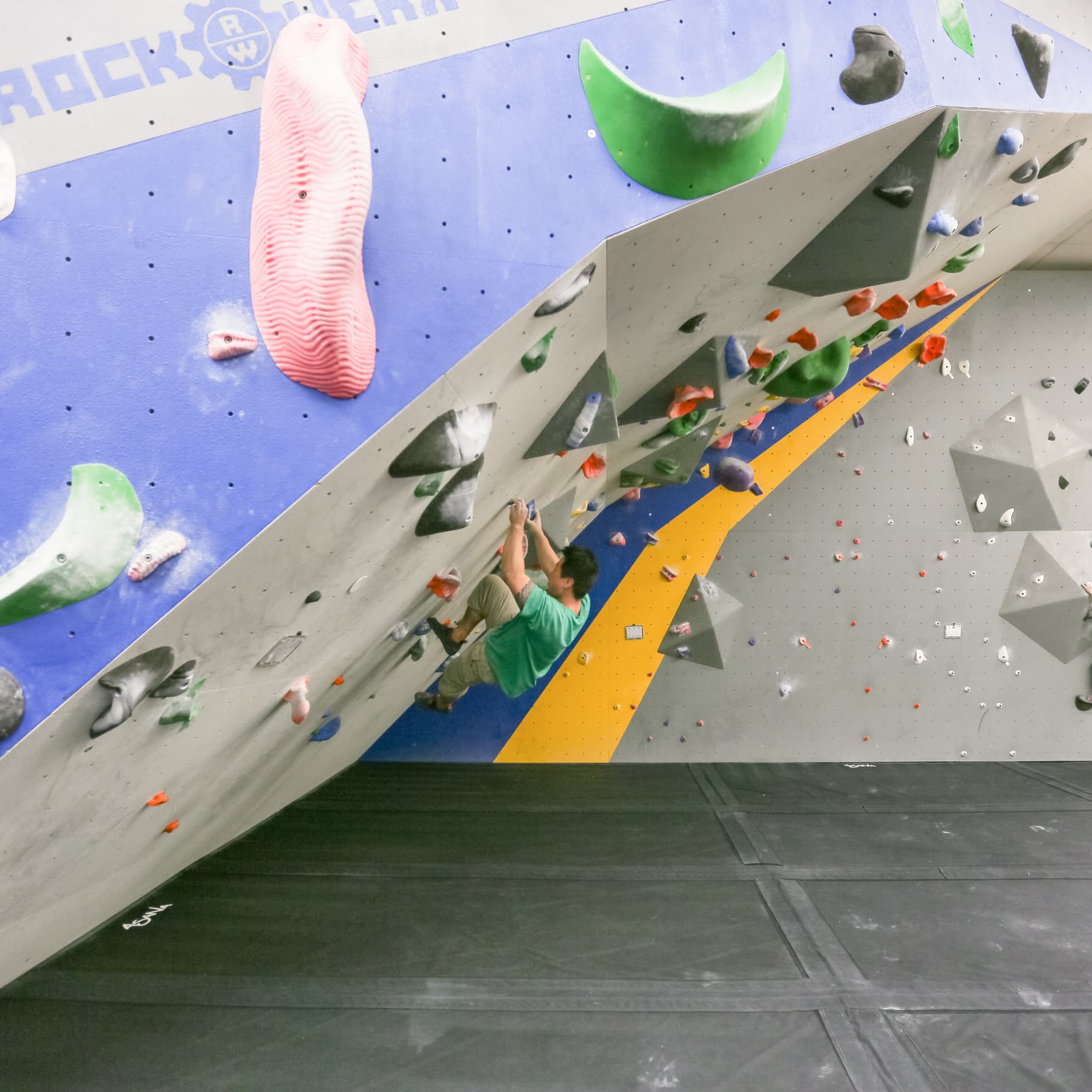 a man bouldering at central rock gym