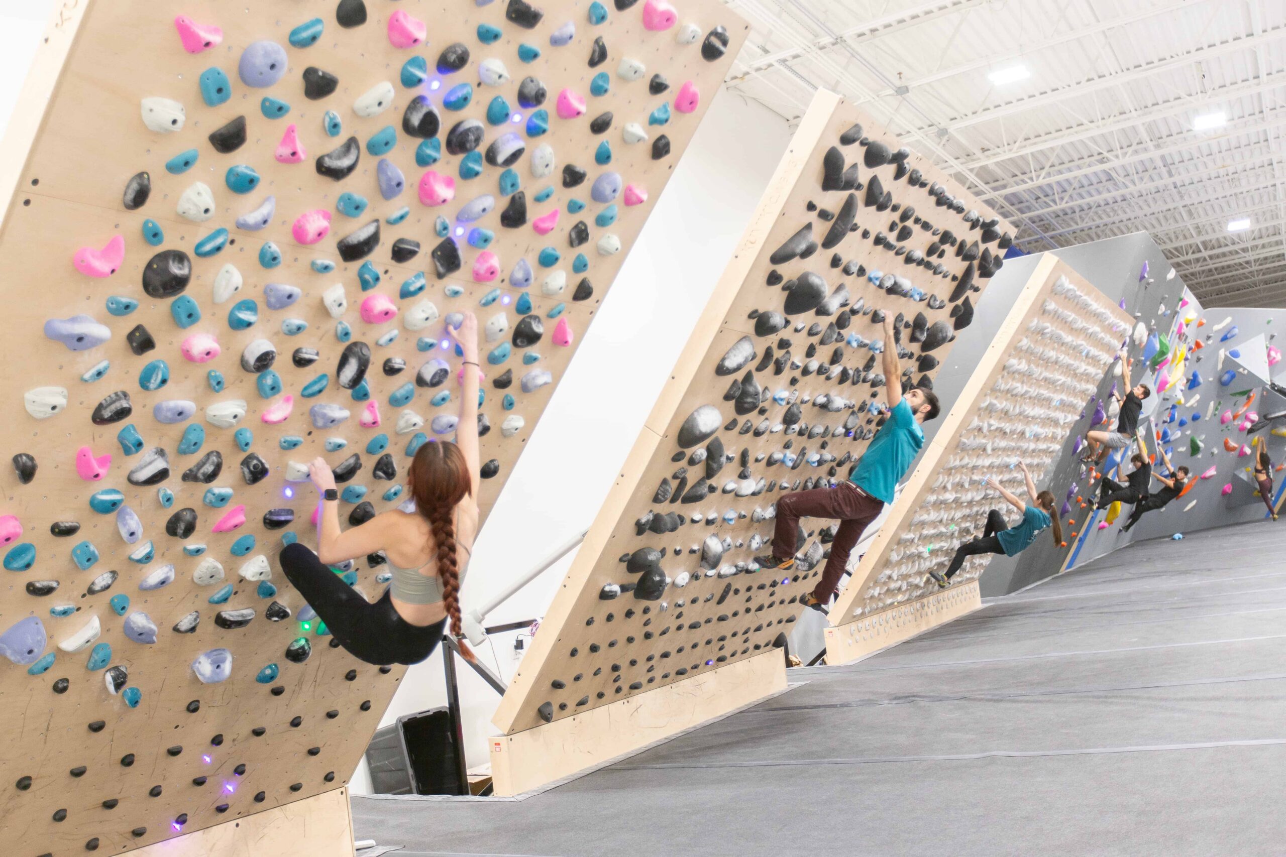a group of people Bouldering at central rock gym
