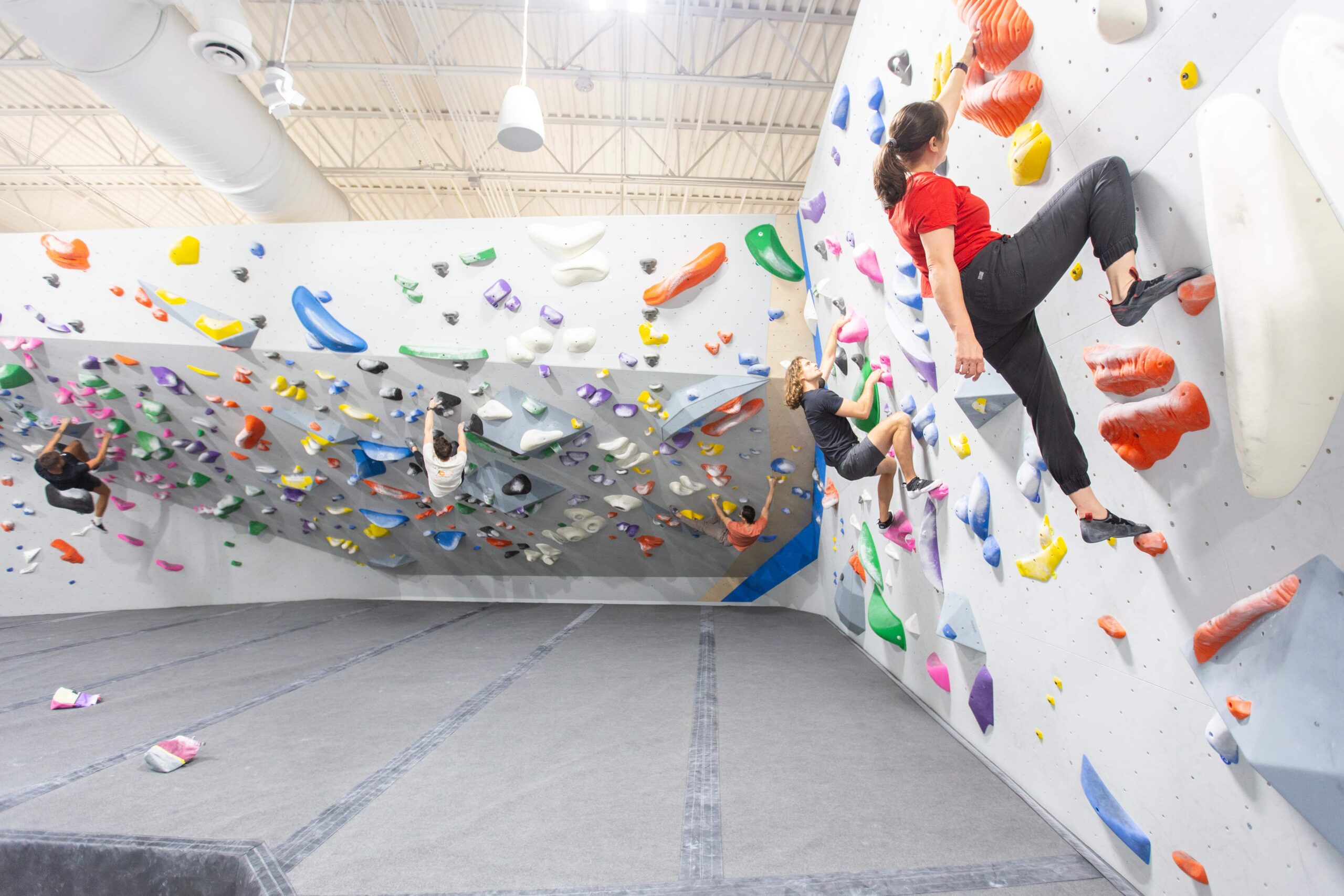 a group of people Bouldering at central rock gym